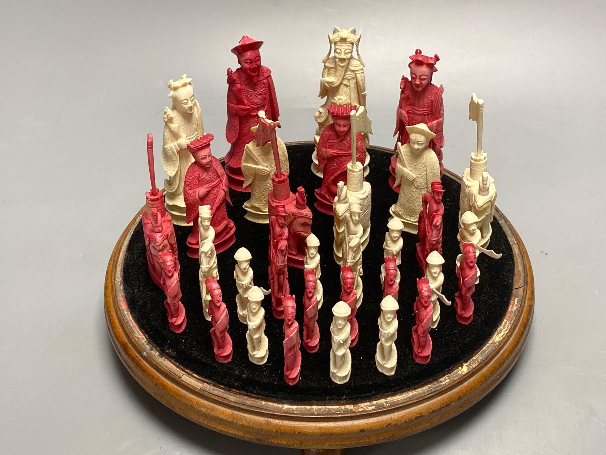 A 19th century Chinese ivory chess set, on a circular mahogany plinth, under glass dome, kings 10cm, dome 38cm